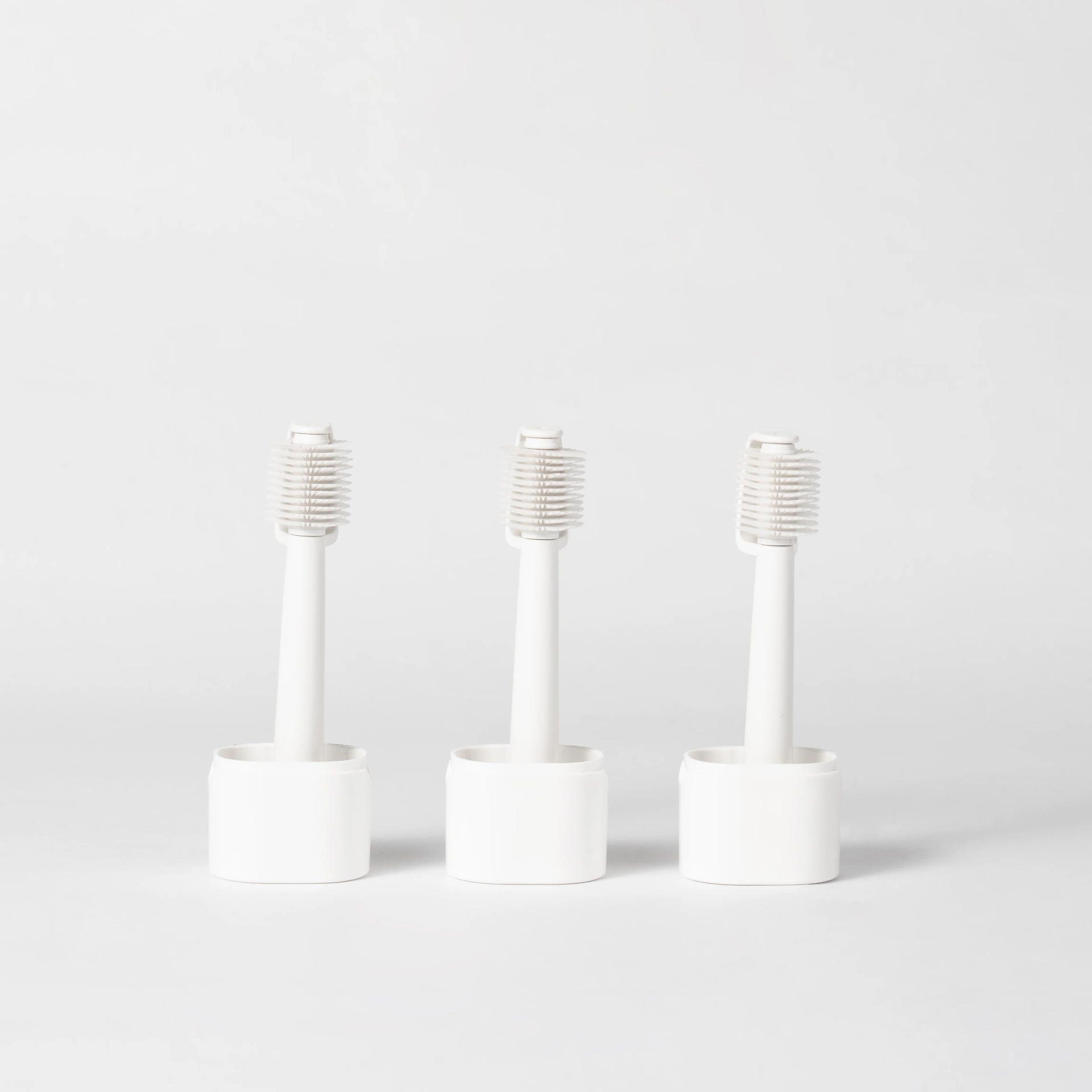 Three Smile Shine replacement brush heads in stands